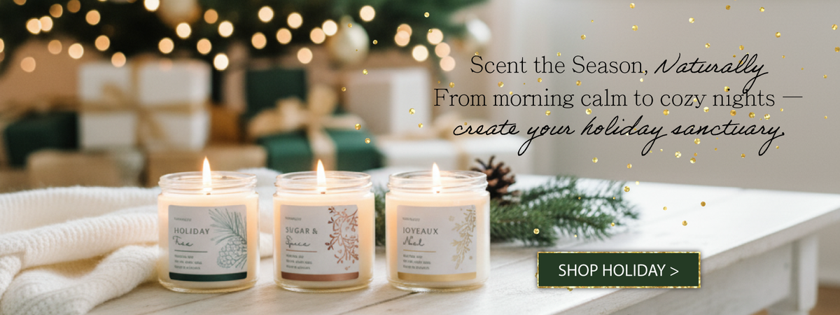 Three candles on a table with holiday decorations and text promoting holiday candles.